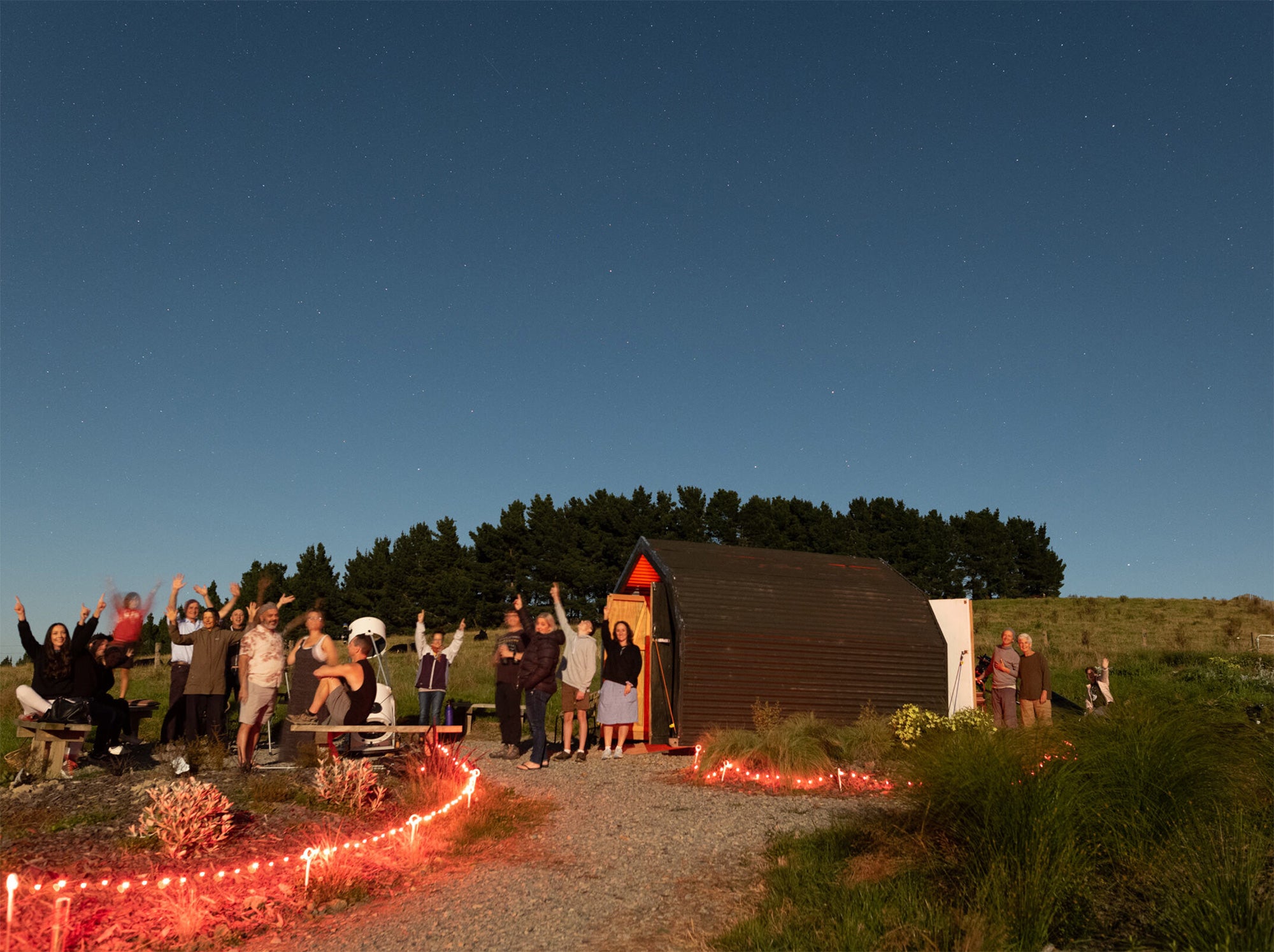 Group of people stargazing at dusk